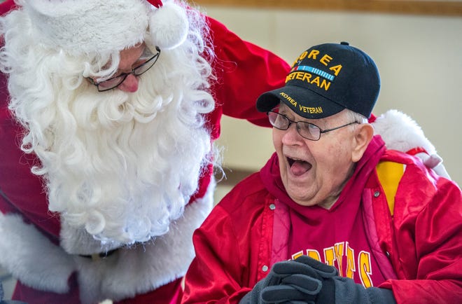 FRED ZWICKY/JOURNAL STAR

Charles Barr from Liberty Village in Peoria laughs after shaking a sleigh bell with Santa at the 2017 Jimmy Binkley Christmas Party for Seniors at the American Legion in Bartonville..