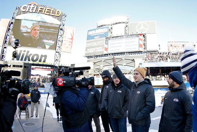 Troy Terry waves to the crowd as the roster for the men's USA Olympic hockey team is announced at the NHL Winter Classic at CitiField in New York.