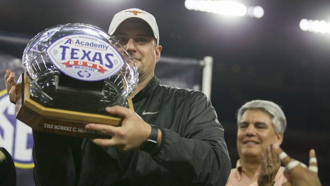 Texas head coach Tom Herman holds up the Robert C. McNair Trophy after beating Missouri 33-16 in the Texas Bowl at NRG Stadium. Herman ended a string of three straight losing seasons when his Longhorns finished 7-6 in his first season this year. CREDIT: Ricardo B. Brazziell/American-Statesman