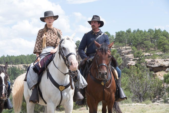 Rosalie Quaid (Rosamund Pike) reluctantly joins Captain Blocker (Christian Bale) on a long trek north. [Entertainment Studios]