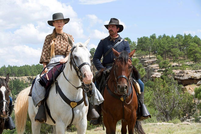 This image shows Rosamund Pike, left, and Christian Bale in a scene from "Hostiles." [Entertainment Studios Motion Pictures]