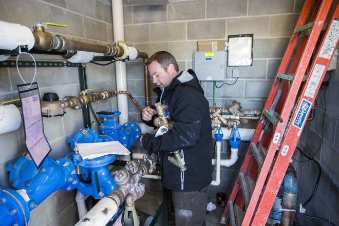 Brian Handt, a plumbing technician for Automatic Fire Systems Inc, works on replacing a water meter that ruptured due to frozen pipes on Tuesday, Jan. 2, 2018, at a business in Cherry Valley. [ARTURO FERNANDEZ/RRSTAR.COM STAFF]