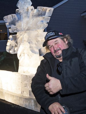 Ice sculptor Wayne DeMoranville poses with last year's signature ice sculpture created for Winterfest in Lakeville. DeMoranville will be back again this year. [File Photo]