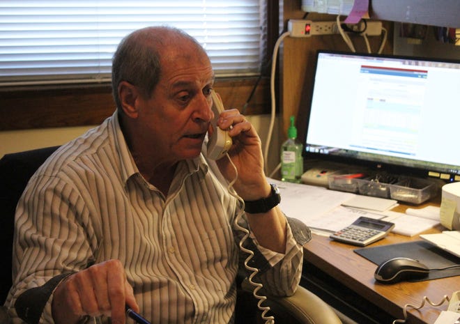 Acushnet Veterans Service Officer Ronald Cormier takes a call at the office. [ROBERT BARBOZA/STANDARD-TIMES SPECIAL/SCMG]