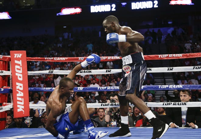 Terence Crawford stands over Julius Indongo, after a punch brought him down in the second round of a junior welterweight world title unification bout in Lincoln, Neb., in August. Bob Hanna named it his Knockdown of the Year. [AP FILE PHOTO]