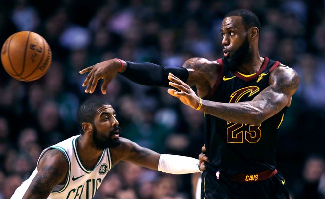 Cleveland Cavaliers forward LeBron James (23) passes the ball as Boston Celtics guard Kyrie Irving defends during the second quarter of an NBA basketball game in Boston, Wednesday, Jan. 3, 2018. (AP Photo/Charles Krupa)