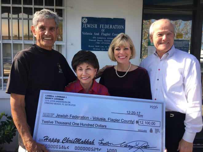 Nancy and Lowell Lohman, right, visited the Jewish Federation’s Jerry Doliner Food Bank in Ormond Beach and donated a $12,100 matching grant. Thanking them for the gift were, from the left, Jewish Federation President Marvin Miller and Executive Director Gloria Max. [Photo provided]