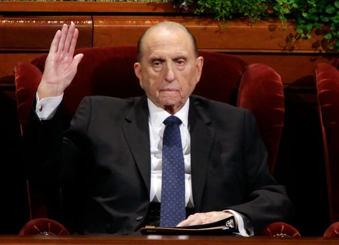 In this April 2, 2016, file photo, President Thomas S. Monson, of The Church of Jesus Christ of Latter-day Saints, raises his hand during a sustaining vote at the two-day Mormon church conference, in Salt Lake City. Monson, the 16th president of the Mormon church, has died after nine years in office. He was 90. (AP Photo/Rick Bowmer, File)