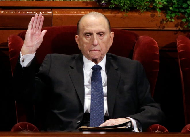 In this April 2, 2016, file photo, President Thomas S. Monson, of The Church of Jesus Christ of Latter-day Saints, raises his hand during a sustaining vote at the two-day Mormon church conference, in Salt Lake City. (AP Photo/Rick Bowmer, File)