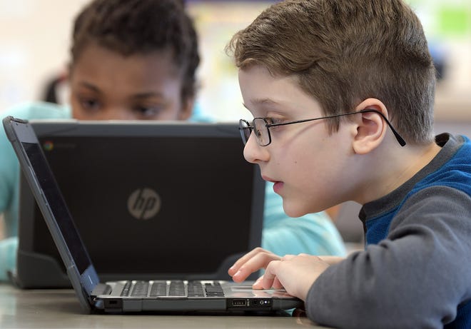 Isaiah Guimaraes, 10, searches for rocks online during a science lesson Wednesday using Chromebooks at Chandler Elementary Community School in Worcester. [T&G Staff/Rick Cinclair]