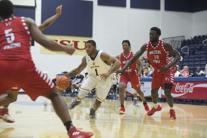 Gulf Coast's Marlon Adams tries to drive through a group of Walters State defenders during a game earlier this season. [JOSHUA BOUCHER/THE NEWS HERALD]