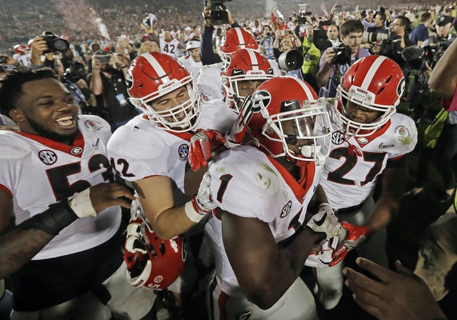 Georgia tailback Sony Michel (1) celebrates with teammates after scoring the game-winning touchdown in the second overtime period to give Georgia a 54-48 win over Oklahoma in the Rose Bowl on Monday in Pasadena, Calif. [AP Photo / Doug Benc, File]