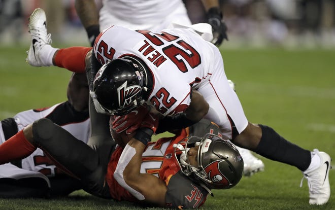 Atlanta Falcons strong safety Keanu Neal (22) takes down Tampa Bay Buccaneers running back Charles Sims (34) on Dec. 18, 2017, in Tampa. Neal, a former South Sumter star, is part of a young Falcons defense that is coming into its own. [AP Photo / Chris O'Meara]