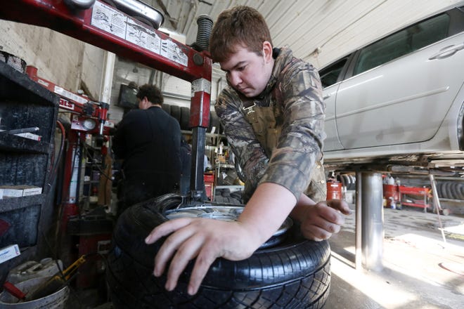 Lowrance Lain, an employee at Roberts Tire Center, mounts a tire on a rim Wednesday at the 1220 Mt. Pleasant St. shop in Burlington. Ed Roberts, owner of Roberts Tire Center, said car owners should check their tire pressure every 60 days, or whenever the signal light turns on in their car. As for other tips to keep cars running smoothly in the cold weather, Bill Roberts suggested making all of the day's stops in one trip rather than in short spurts throughout the day if possible. [John Lovretta/thehawkeye.com]