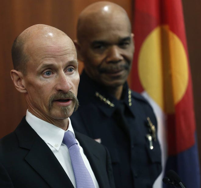 FILE - In this March 26, 2015, file photo, then First Assistant U.S. Attorney Robert Troyer, left, flanked by Denver Police Chief Robert White, takes questions during a news conference in Denver discussing an indictment alleging that 32 people exported tons of marijuana to other states over four years. Troyer, who is now Colorado’s U.S. Attorney, said his office will not change its approach to prosecuting marijuana crimes despite a change in policy by Attorney General Jeff Sessions giving federal prosecutors more leeway to enforce laws against pot. (AP Photo/Brennan Linsley, File)