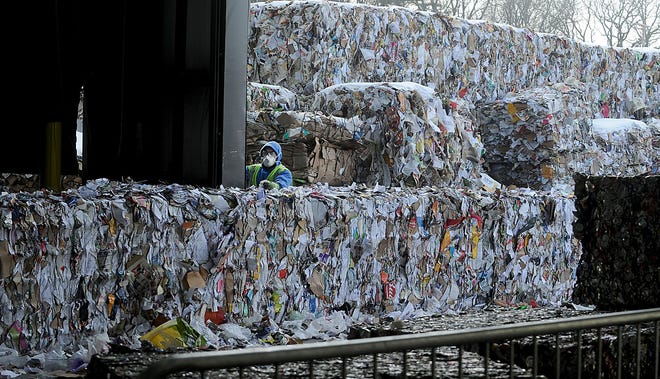 Bales of compacted paper from residential single stream recyclables at E.L. Harvey, piling up outside the Material Recycling Facility. [Daily News and Wicked Local Staff Photo/Art Illman]