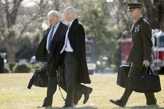 President Donald Trump's Chief of Staff John Kelly, left, and White House Director of Legislative Affairs Marc Short, second from left, walk toward Marine One on the South Lawn of the White House in Washington Friday to travel with President Donald Trump to Camp David in Maryland. [ANDREW HARNIK/ASSOCIATED PRESS]