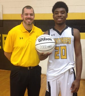 Kings Mountain senior Adrian Delph reached a rare milestone, topping the 2,000-point mark for his high school career during his 28-point night in a win over county rival Burns on Friday. Coach Grayson Pierce presented a keepsake basketball for the occasion. [Alan Ford / The Star]
