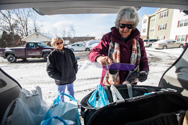 Volunteers Betsy McCurdy and Joan Danek make a delivery Friday to the Temple Hill apartments in New Windsor for Meals on Wheels of Greater Newburgh. [KELLY MARSH/FOR THE TIMES HERALD-RECORD]