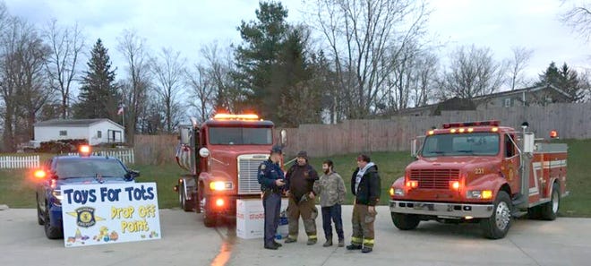 Members of the Camden Fire Department joined the Michigan State Police to collect toys at Dollar General in Camden in early December. [COURTESY PHOTO]