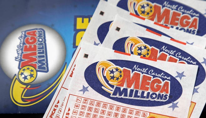 FILE - In this July 1, 2016, file photo, Mega Millions lottery tickets rest on a counter at a Pilot travel center near Burlington, N.C. The jackpot for the Mega Millions lottery game has climbed to over $450 million, just hours before the drawing, Friday, Jan. 5, 2018. (AP Photo/Gerry Broome, File)