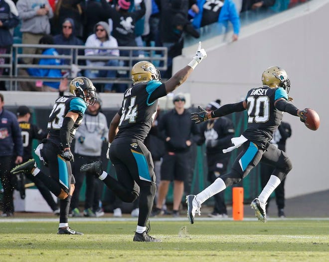 Jaguars cornerback Jalen Ramsey (20) celebrates with a teammate after intercepting a pass against the Bills in the final seconds.