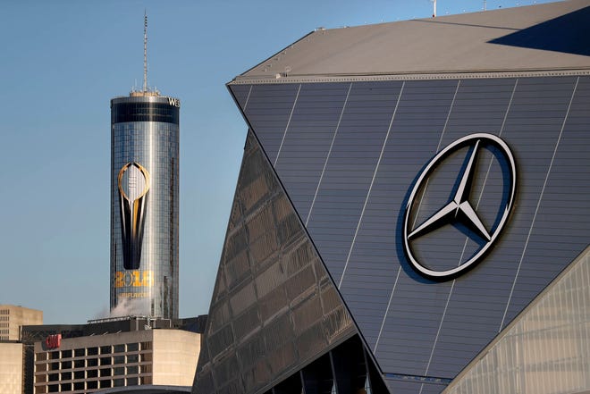 A logo for the NCAA college football championship game decorates a building next to Mercedes-Benz Stadium Thursday, Jan. 4, 2018, in Atlanta, where the game will be played on Monday. Atlanta’s mayor is promising a “safe, smooth and secure” college football championship game Monday, despite the traffic problems expected to be caused by President Donald Trump’s motorcade, but none of the many agencies involved are taking any chances. (AP Photo/David Goldman)