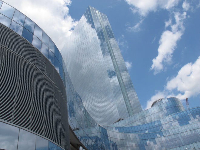This May 10, 2012 photo shows clouds reflected in the glass facade of the former Revel casino in Atlantic City N.J. On Monday Jan. 8, 2018, Colorado developer Bruce Deifik announced he has bought the shuttered casino from former owner Glenn Straub for $200 million, and plans to reopen it in summer 2018. [AP Photo/Wayne Parry]