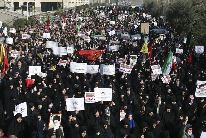 Iranian protesters rally on Dec. 30 in Tehran. Widespread protests against Iran's theocratic regime broke out across the country last week. [EBRAHIM NOROOZI/THE ASSOCIATED PRESS]