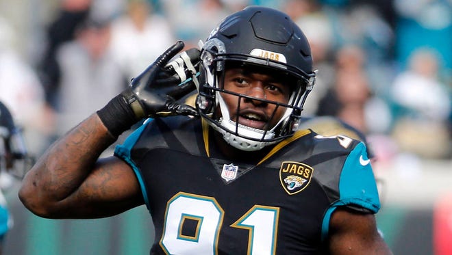 Jacksonville Jaguars defensive end Yannick Ngakoue encourages the fans to cheer in the first half of an NFL wild-card playoff football game against the Buffalo Bills, Sunday, Jan. 7, 2018, in Jacksonville, Fla. (AP Photo/Stephen B. Morton)