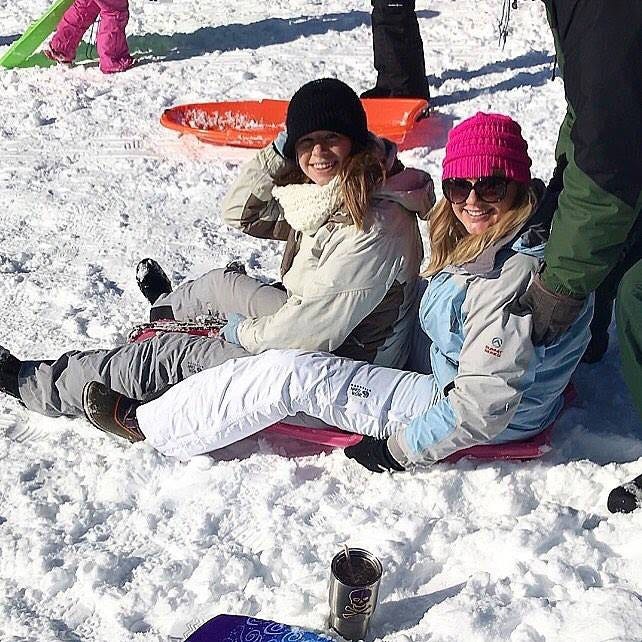 Leanna Tyson and Emily Woolard enjoy the snow by sledding at the New Bern Golf & Country Club this past week. [Photo courtesy of Leanna Tyson]