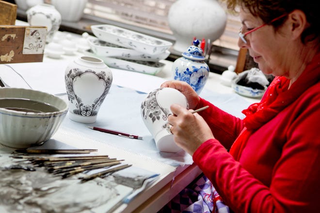Royal Delft artists spend on average eight years learning how to hand paint the iconic Dutch pieces. Using brushes made from the hairs of martens and squirrels, they apply black paint that contains cobalt oxide. During the firing, the cobalt activates and causes the color to change from black to blue. [PHOTO PROVIDED BY ROYAL DELFT]