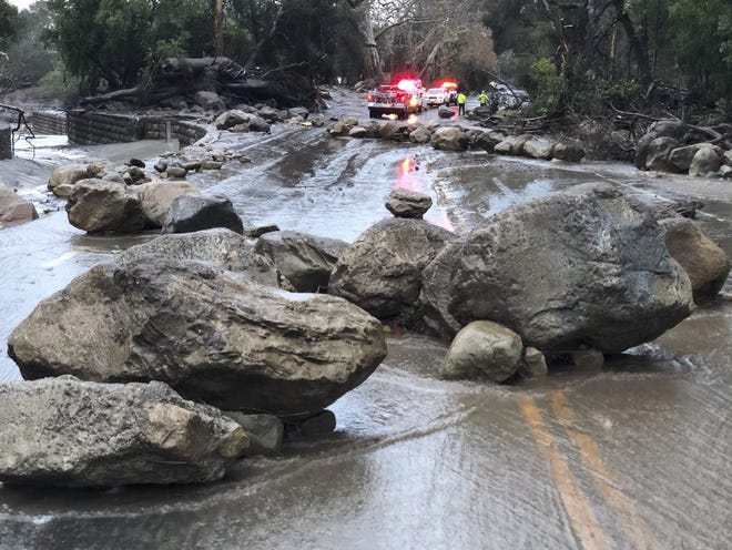 In this photo provided by Santa Barbara County Fire Department, mud and debris flow on the roadway due to heavy rain in Montecito. Calif., Tuesday, Jan. 9, 2018. Heavy rains pounding Southern California for a second day are causing floods and loosening hillsides as officials in fire-ravaged communities warn people to stay off roads over fears of mud and debris flows. (Mike Eliason/Santa Barbara County Fire Department via AP)