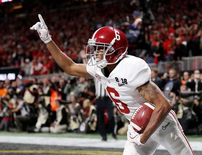 Alabama wide receiver DeVonta Smith celebrates his game-winning touchdown during overtime of the NCAA college football playoff championship game against Georgia.