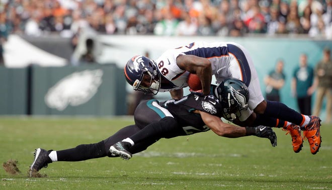 Denver Broncos’ Demaryius Thomas (88) is tackled by Philadelphia Eagles’ Patrick Robinson (21) during a game Nov. 5 in Philadelphia. Jim Schwartz’s defense did what no other unit could do in 2016: Stop the high-flying Falcons. They have to do it again with an NFC championship berth at stake. (AP Photo/Matt Rourke, File)
