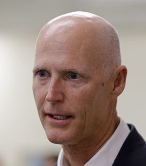 Gov. Rick Scott answers a question to a reporter Tuesday, Sept. 15, 2015, in Miami. [File Photo]