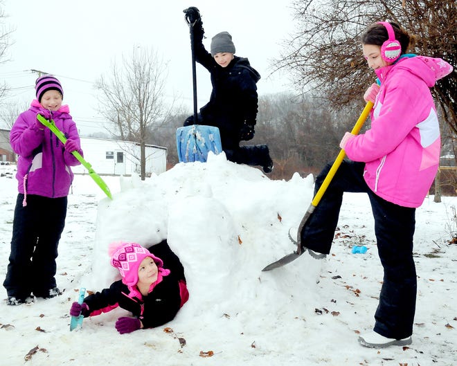 The several inches of snow that fell Monday made for hazardous driving for motorists but also made for a good time for area youth. These children on the west end of Cambridge, spent hours gathering snow and then constructing an igloo next to their home. They include Nevaeh Tabler in the dome, and Brigette Bailey, left, Anthony Tabler, top, and Brittany Bailey.
