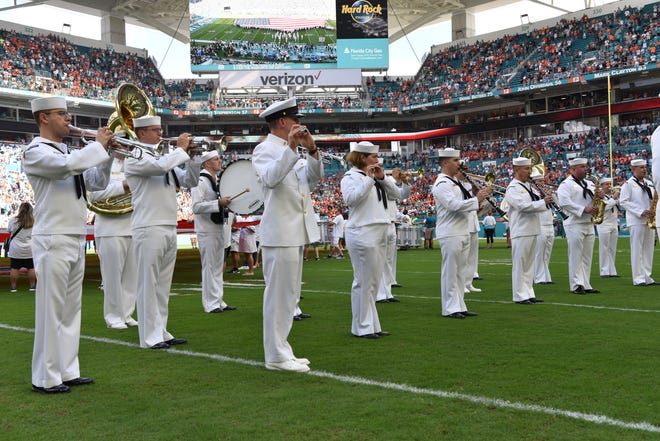The Navy Band Southeast Marching Band performs the National Anthem for the Miami Dolphins vs. Denver Broncos NFL Game in Hard Rock Stadium, Miami Gardens, Dec. 3.