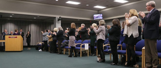 Cathy Cloninger is given a standing ovation during the ceremony at the Gaston County Board of Commissioners meeting where is was announced that The Shelter of Gastonia will be renamed to the Cathy Marby Cloninger Center-A Domestic Violence Shelter in her honor after her retirement as shelter coordinator. [JOHN CLARK/THE GASTON GAZETTE]