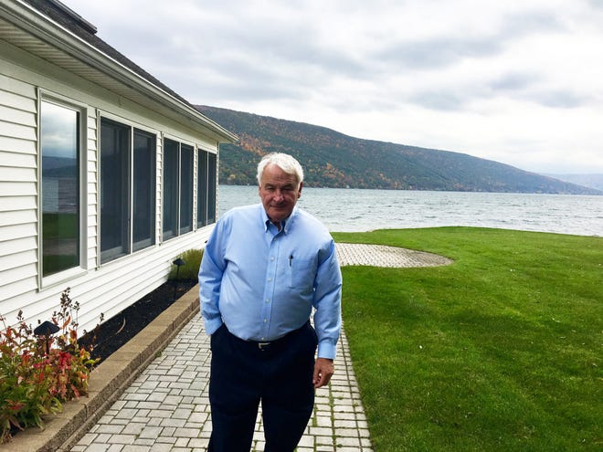 Tom Golisano stands outside his lake home in South Bristol this past autumn. Golisano says geese have overrun his property, making it unusable for enjoyment and unhealthy for the lake. He has withheld school taxes to the Naples district. [JULIE SHERWOOD/MESSENGER POST MEDIA FILE PHOTO]