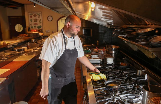 Mike Snyder prepares an egg to be topped with shaved truffles at MarchÃ©. (Collin Andrew/The Register-Guard)