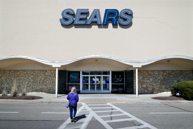In this March 22, 2017, file photo, a shopper walks up to a Sears department store at the Tri-County Mall, in Springdale, Ohio. (AP Photo/John Minchillo, File)
