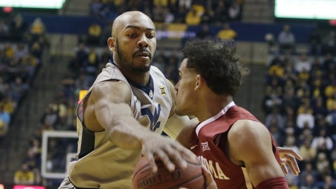 West Virginia guard Jevon Carter, left, tries to knock the ball away from Oklahoma guard Trae Young last week during a Big 12 basketball matchup. Carter has averaged 16.1 points, 6.8 assists, 5.5 rebounds and 3.6 steals per game this season, helping the Mountaineers start 4-0 in conference play. CREDIT: Raymond Thompson/AP Photo