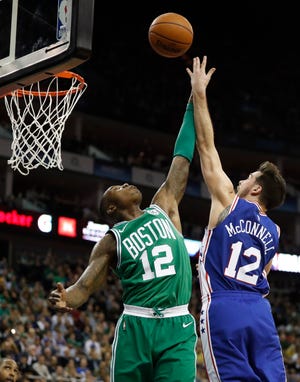 Boston Celtics guard Terry Rozier, left, goes up against 76ers guard T.J. McConnell at the O2 Arena in London on Thursday. [AP Photo/Kirsty Wigglesworth]