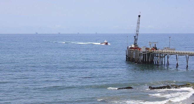 This May 16, 2015 photo shows oil drillings offshore of a service pier in the Santa Barbara Channel off the coast of Southern California near Carpinteria. Opposition to the Trump administrationís plan to expand offshore drilling mounted Wednesday, Jan. 10, 2018. The plan could open up federal waters off the California coast for the first time in more than three decades. The Channel is one of those areas that could open up. (AP Photo/John Antczak, File)