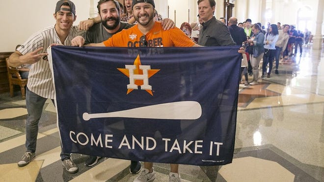 Longtime fans, from left, Joe Kalla, Jeremy Smith and Anthony Ramirez, brought some items to show their support for the Astros as they wait in line to view the World Series trophy. The Houston Astros World Series trophy tour arrived in Austin at the Texas Governor’s Reception Room in the State Capitol for a public viewing Tuesday afternoon January 9, 2018. RALPH BARRERA / AMERICAN-STATESMAN