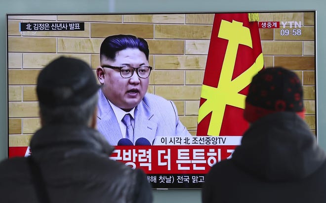 South Koreans watch a TV news program showing North Korean leader Kim Jong Un's New Year's speech at the Seoul Railway Station Jan. 1 in Seoul South Korea. Kim said in his New Year's address he is willing to send a delegation to the Pyeongchang Olympics. [Lee Jin-man/The Associated Press]