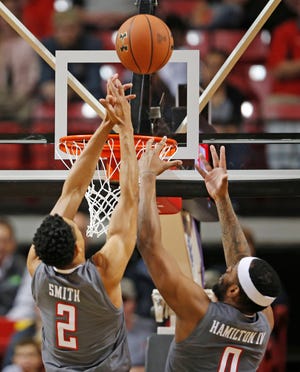 Texas Tech’s Zhaire Smith (2) and Tommy Hamilton (0) try to rebound the ball at the net during the first half of an NCAA college basketball game against Baylor, Friday, Dec. 29, 2017, in Lubbock, Texas. (AP Photo/Brad Tollefson)