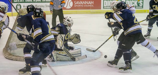 A host of Georgia Tech defenders swarm to protect the goal from a scoring attempt by FSU’s Chris Brown (2) in the Savannah Hockey Classic on Friday night.(Robert Cooper/For the Savannah Morning News)