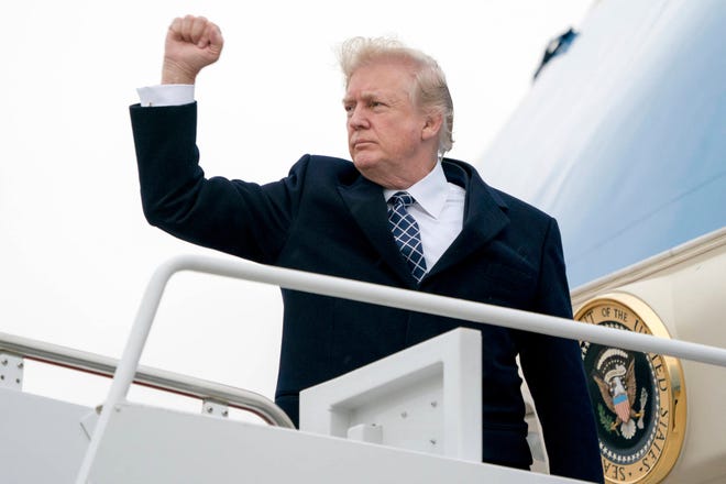 President Donald Trump gestures as he boards Air Force One at Andrews Air Force Base, Md., Friday, Jan. 12, 2018, to travel to Palm Beach International Airport in West Palm Beach, Fla. (AP Photo/Andrew Harnik. (AP Photo/Andrew Harnik)